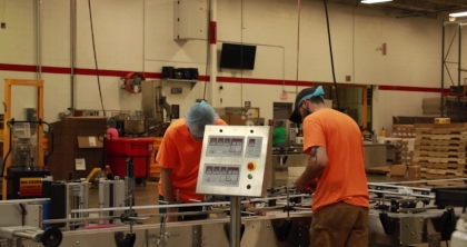 Interior view - workers calibrate wet wipe production line